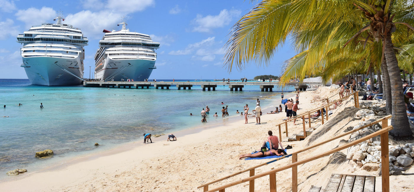 Image: Carnival Cruise ships docked side-by-side in the Caribbean. (Photo via iStock Editorial / Getty Images / Debbie Ann Powell)