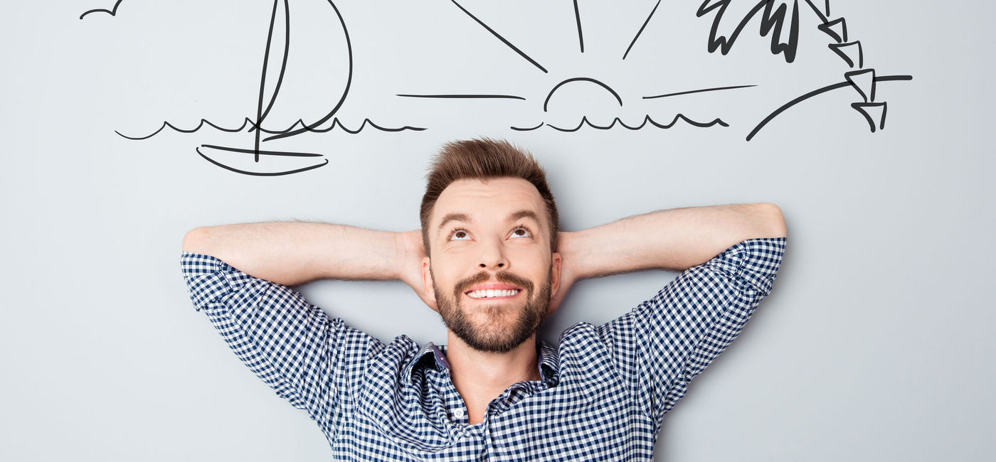 Image: Man daydreaming about travel. (Photo via Deagreez / Stock / Getty Images Plus)