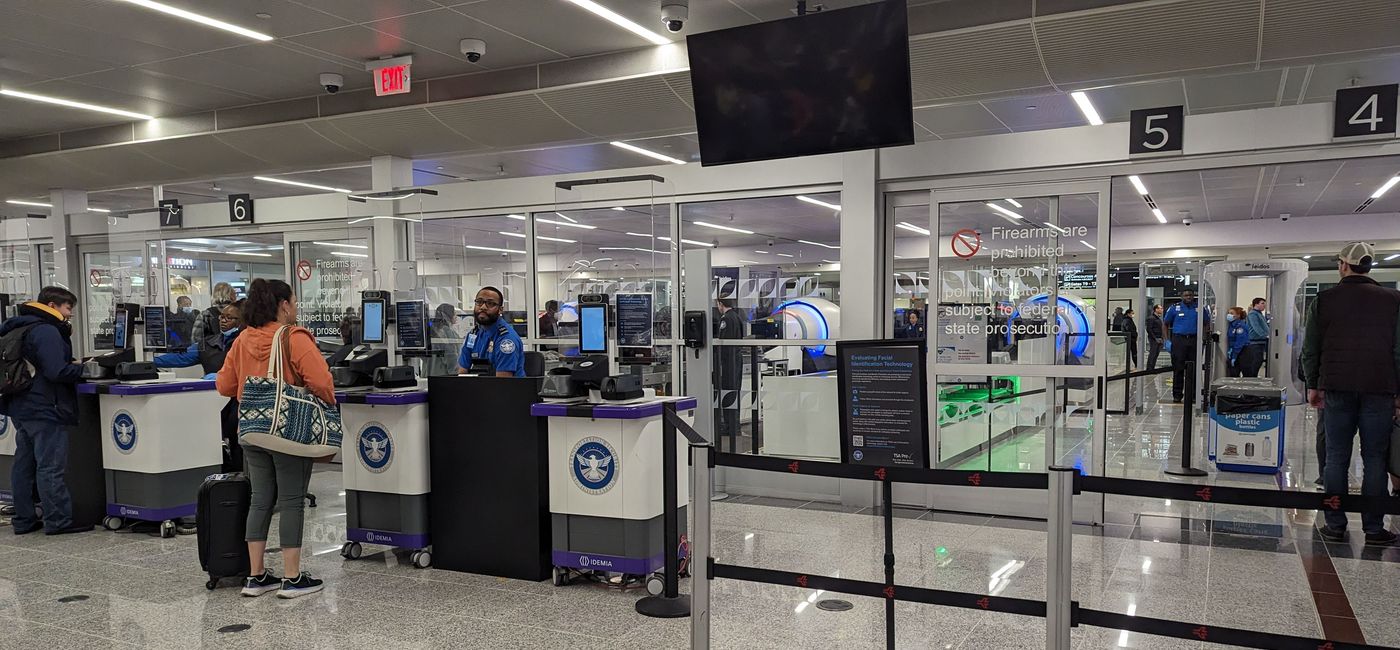 Image: A traveler checks in with TSA security. (photo by Eric Bowman)