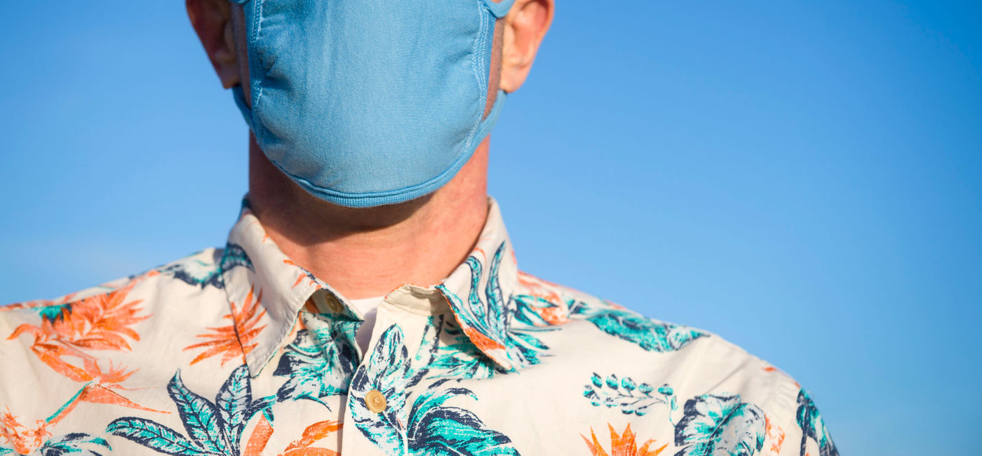 Image: Traveler wearing a face mask. (photo via PeskyMonkey/iStock/Getty Images Plus)