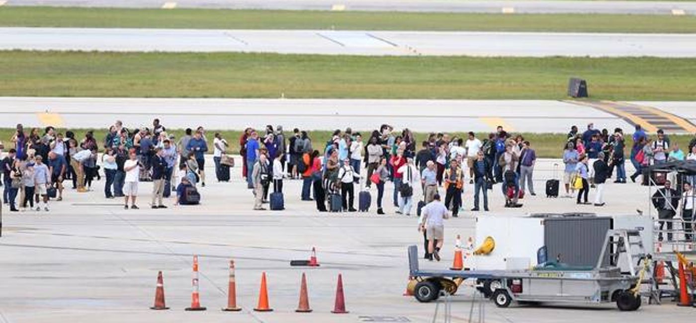 Image: Passengers gather on the tarmac in the aftermath of the shooting Friday at Fort Lauderdale-Hollywood International Airport. (Courtesy Twitter/Scott Eddy)