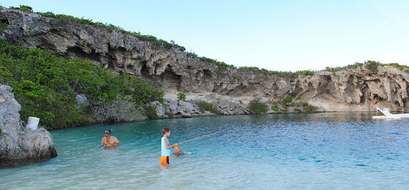 Image: PHOTO: A family in the cove of Dean’s Blue Hole (Photo via Flickr/bookfinch)