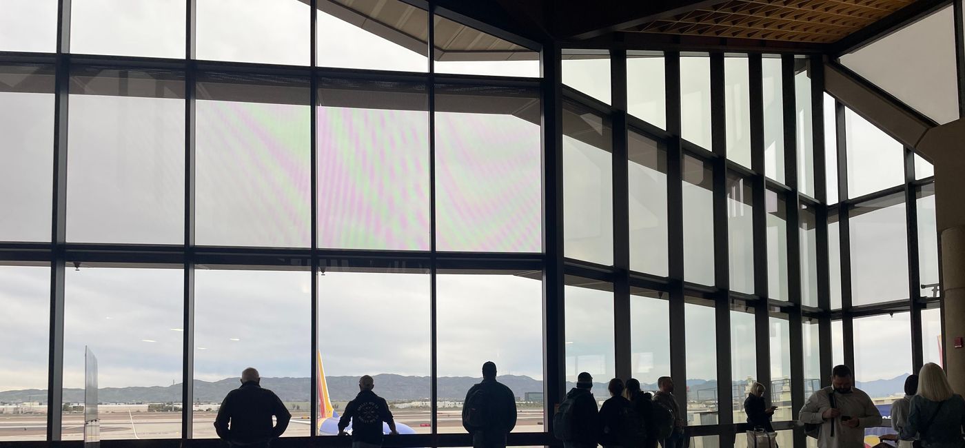 Image: Travelers look on at Phoenix Sky Harbor International Airport. (photo by Patrick Clarke)