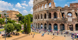 Colosseum with clear blue sky and clouds in Rome, Italy