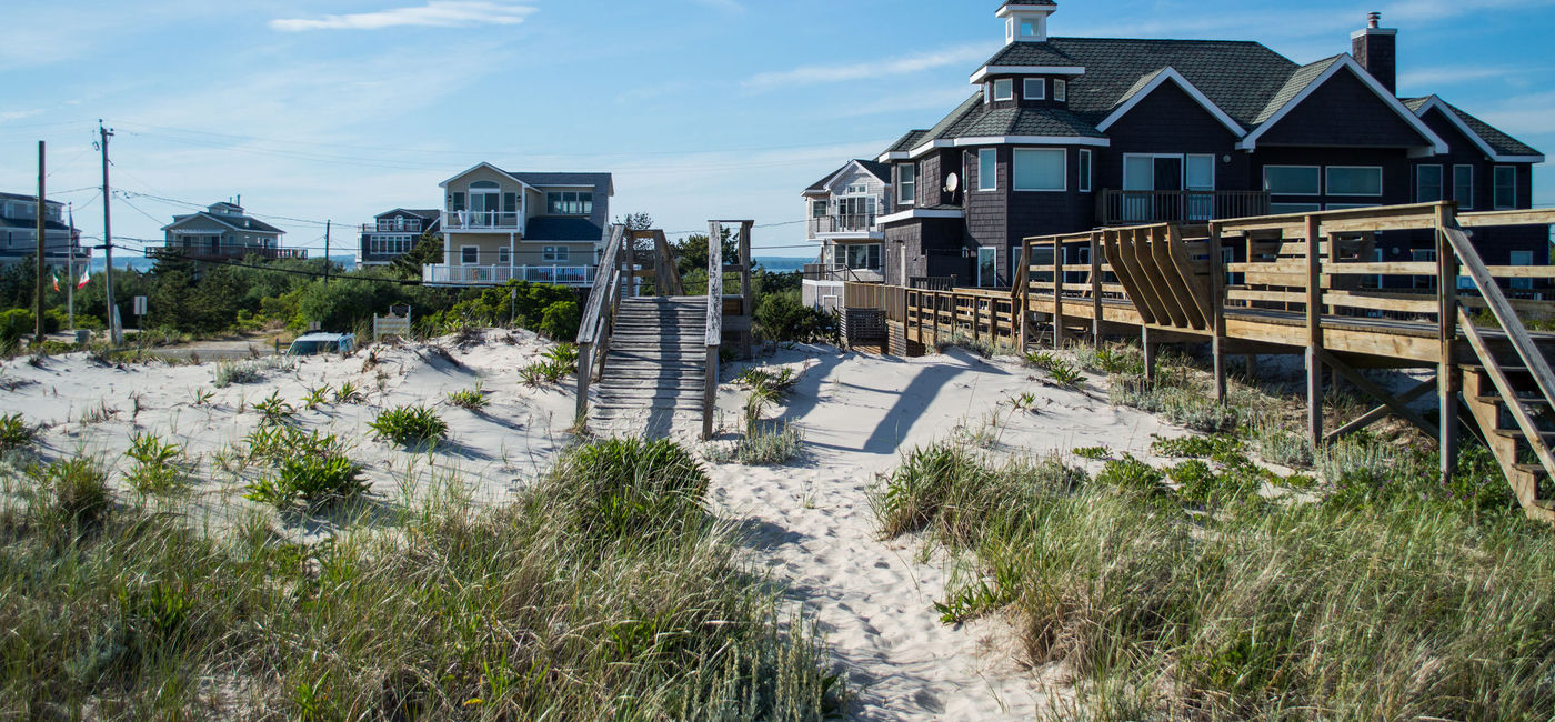 Image: Summer beach houses in The Hamptons, New York. (photo via Miles Astray/iStock/Getty Images Plus)