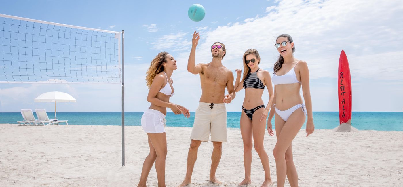 Image: Friends playing beach volleyball. (photo via Trump International Beach Resort)