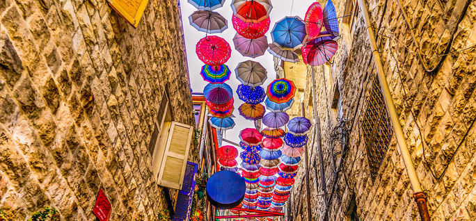 Alley in old Amman decorated with colourful umbrellas, Kingdom of Jordan.