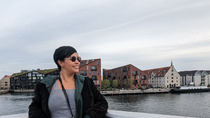 A tourist hangs out by the Copenhagen Harbor