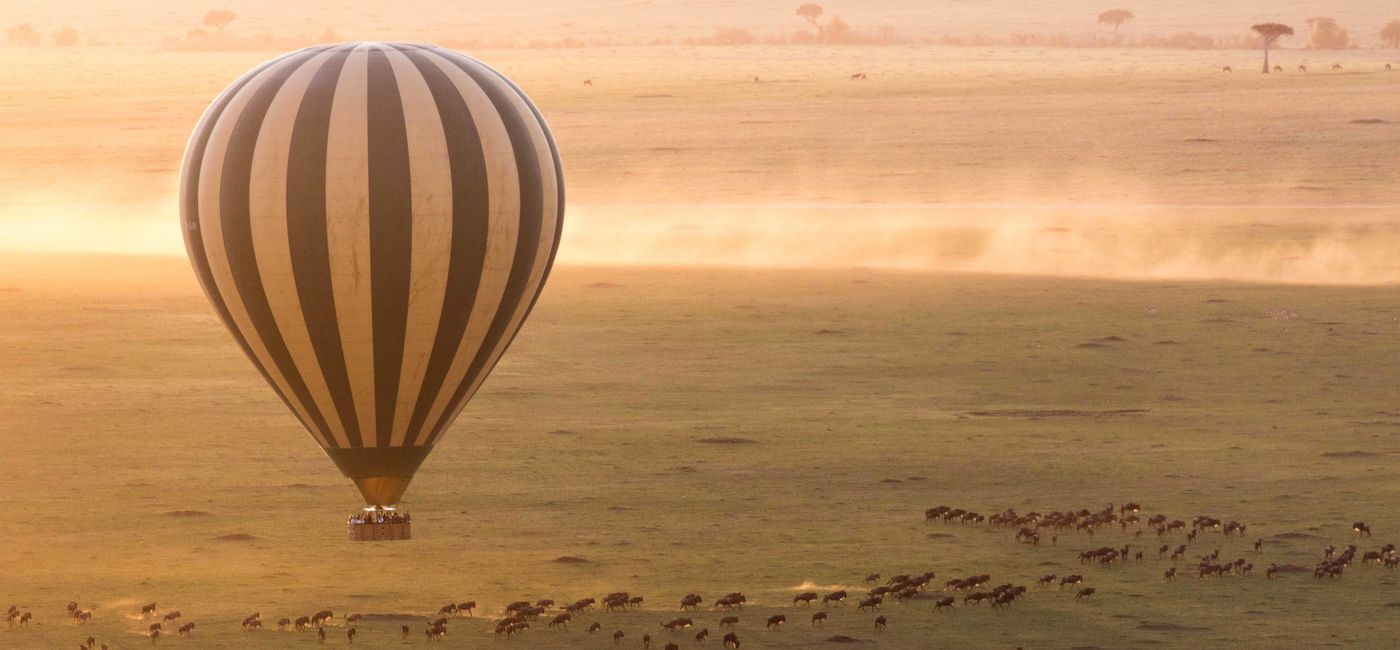 Image: A hot air balloon hovers over the Great Migration in Kenya on a trip with Ker & Downey Africa. (photo via Ker & Downey Africa) ((photo via Ker & Downey Africa))