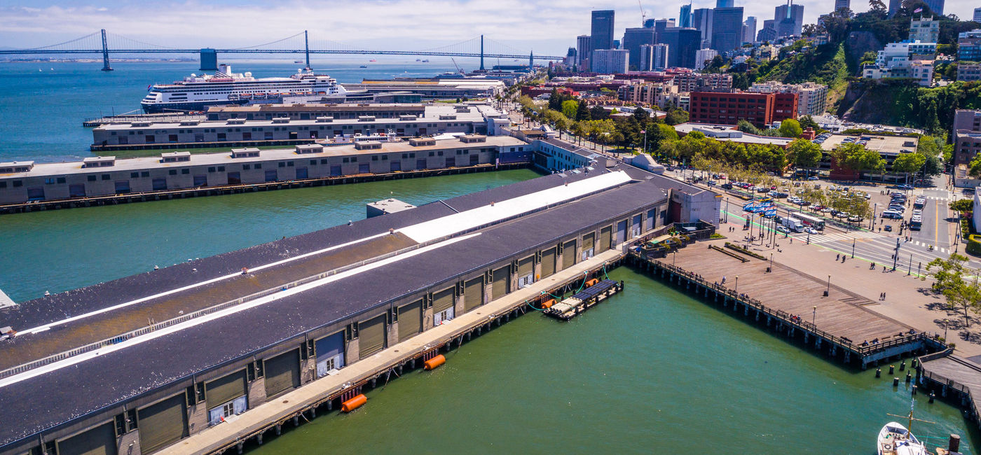 Image: Port of San Francisco's commercial docks with the Oakland Bay Bridge in the background. (photo via iStock/Getty Images Plus/RoschetzkyIstockPhoto)