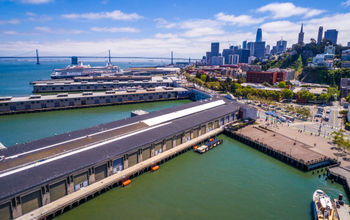 Port of San Francisco's commercial docks with the Oakland Bay Bridge in the background.