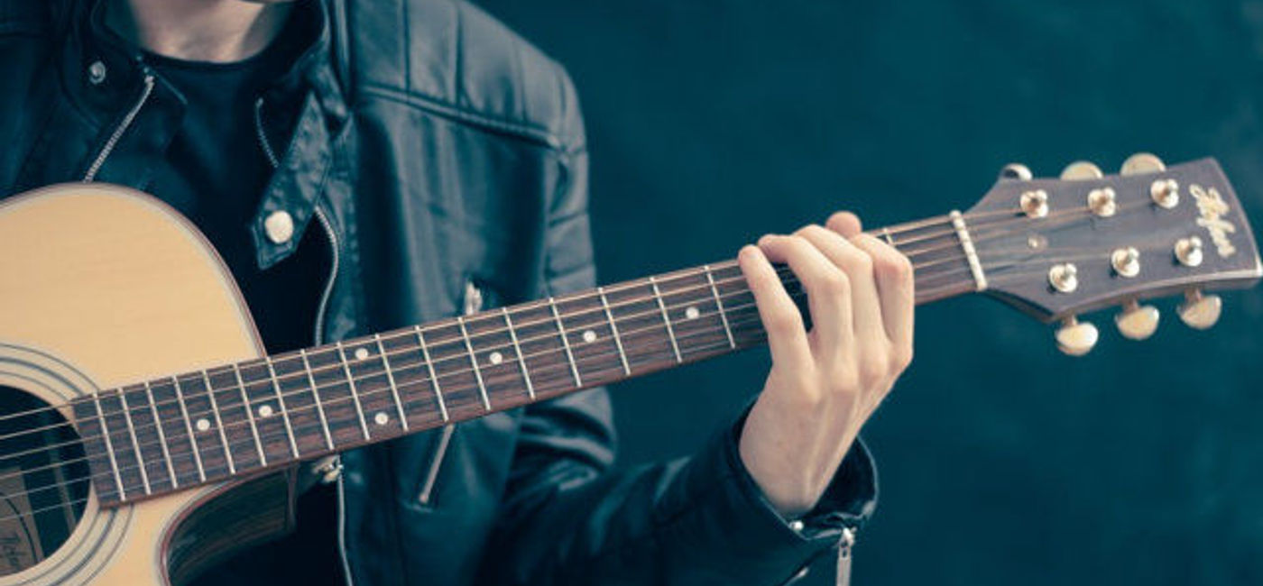 Image: PHOTO: Man playing acoustic guitar. (photo via Pixabay/Firm Bee)