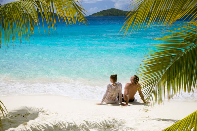 Couple relaxing on a beach in the Caribbean Couple relaxing on a beach in the Caribbean