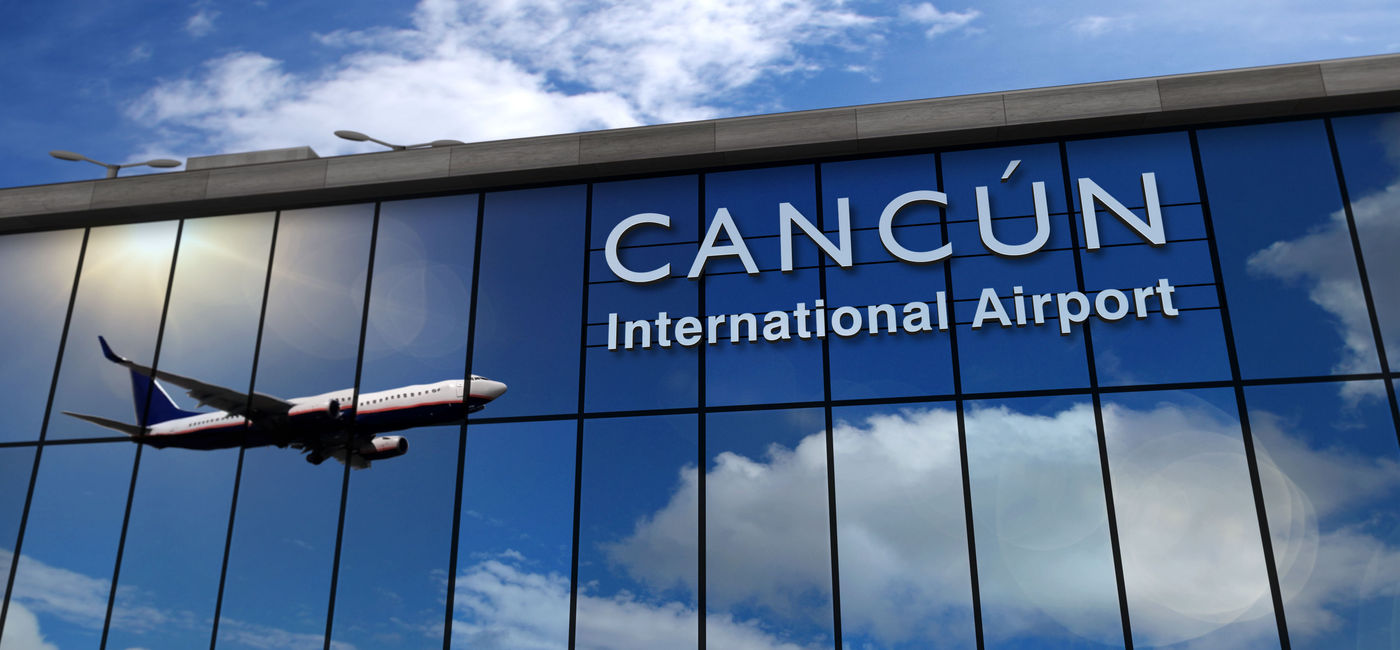 Image: Airplane landing at Cancun airport. (photo via Arkadiusz Wargula / iStock / Getty Images Plus)