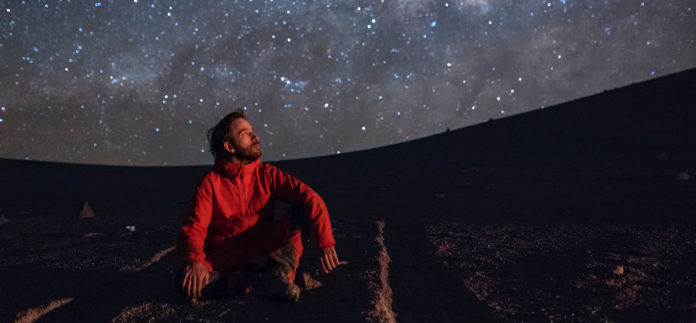 Image: Man observing the Milky Way galaxy in the Atacama Desert, Chile. (photo via iStock/Getty Images Plus/abriendomundo)
