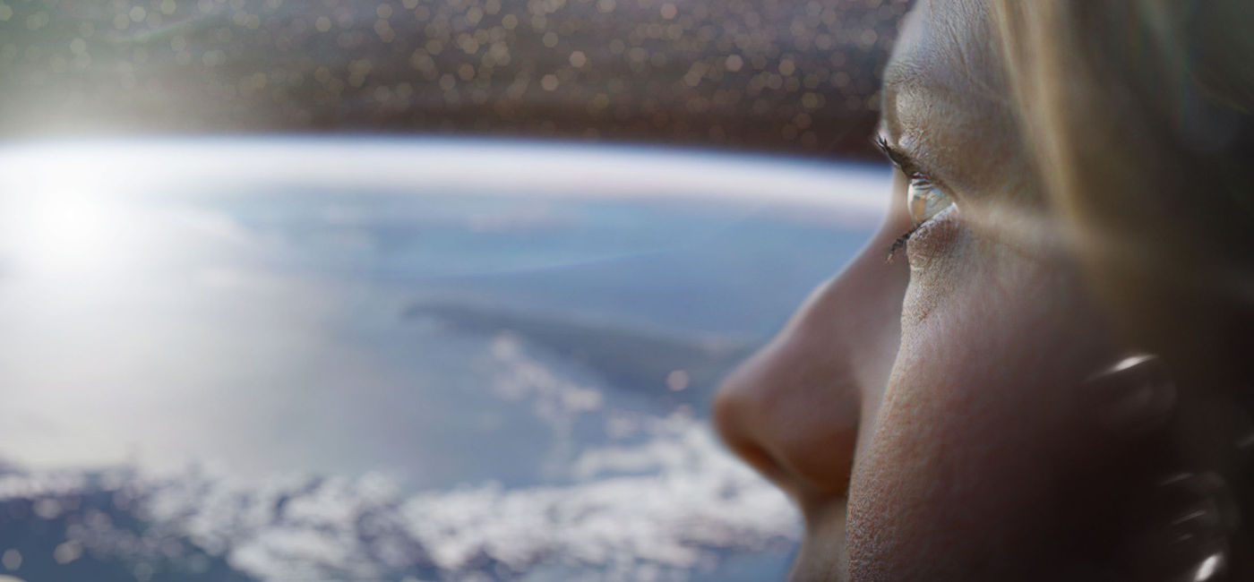 Image: A woman looks at the view of Earth from above. (photo via Space Perspective) ((photo via Space Perspective))