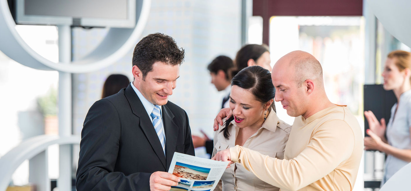 Image: Couple meets with a travel agent. (photo via Getty Images) (vm/iStock/Getty Images)