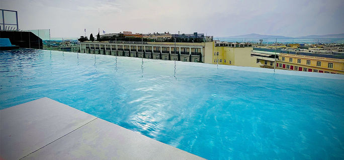 The rooftop pool is a highlight with views of the city and the Acropolis. 