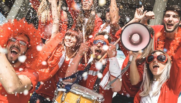 A group of cheering soccer fans