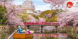 Boat ride on the moat of Himeji Castle with cherry blossoms in Japan.