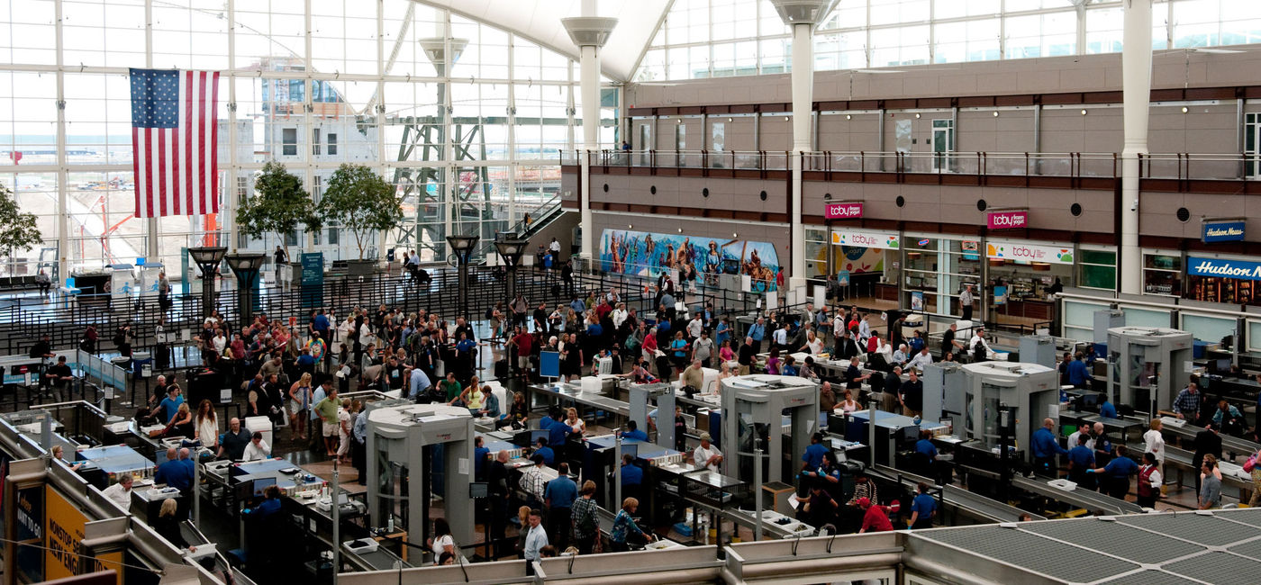 Image: People traveling through security at Denver International Airport. (photo via 400tmax/iStock Unreleased)