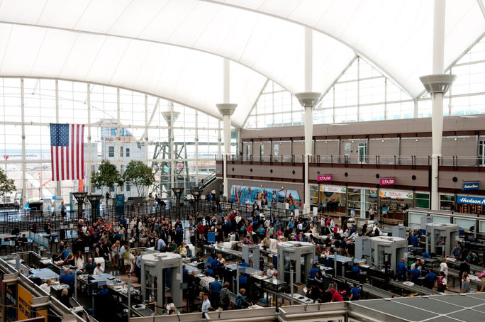 People traveling through security at Denver International Airport People traveling through security at Denver International Airport