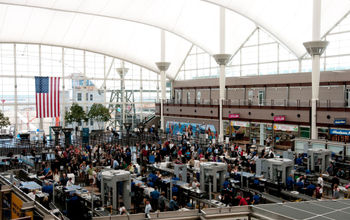 People traveling through security at Denver International Airport