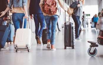 People walking through an airport terminal.