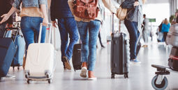 People walking through an airport terminal.