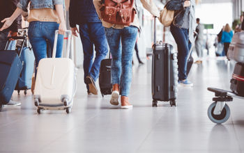 People walking through an airport terminal.