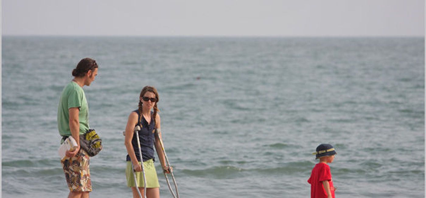 Image: PHOTO: A tourist on crutches visiting a beach. (photo via Flickr/nevil zaveri)