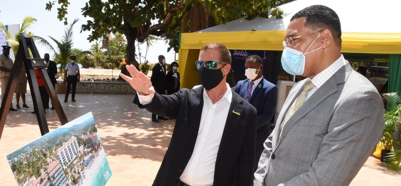 Image: "This illustrates the confidence we have always had as a family in the Caribbean." Adam Stewart (left), shown here with Jamaica Prime Minister Andrew Holness. (Courtesy of Sandals Resorts International)