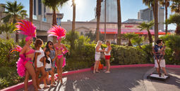 Showgirls posing with tourists in Las Vegas