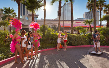 Showgirls posing with tourists in Las Vegas
