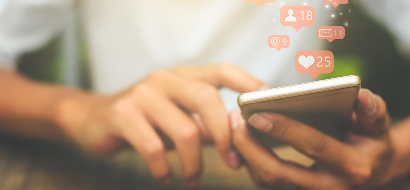 Image: PHOTO: Using social media on a smartphone. (photo via Urupong/iStock/Getty Images Plus)