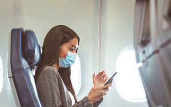 Masked passenger on plane.