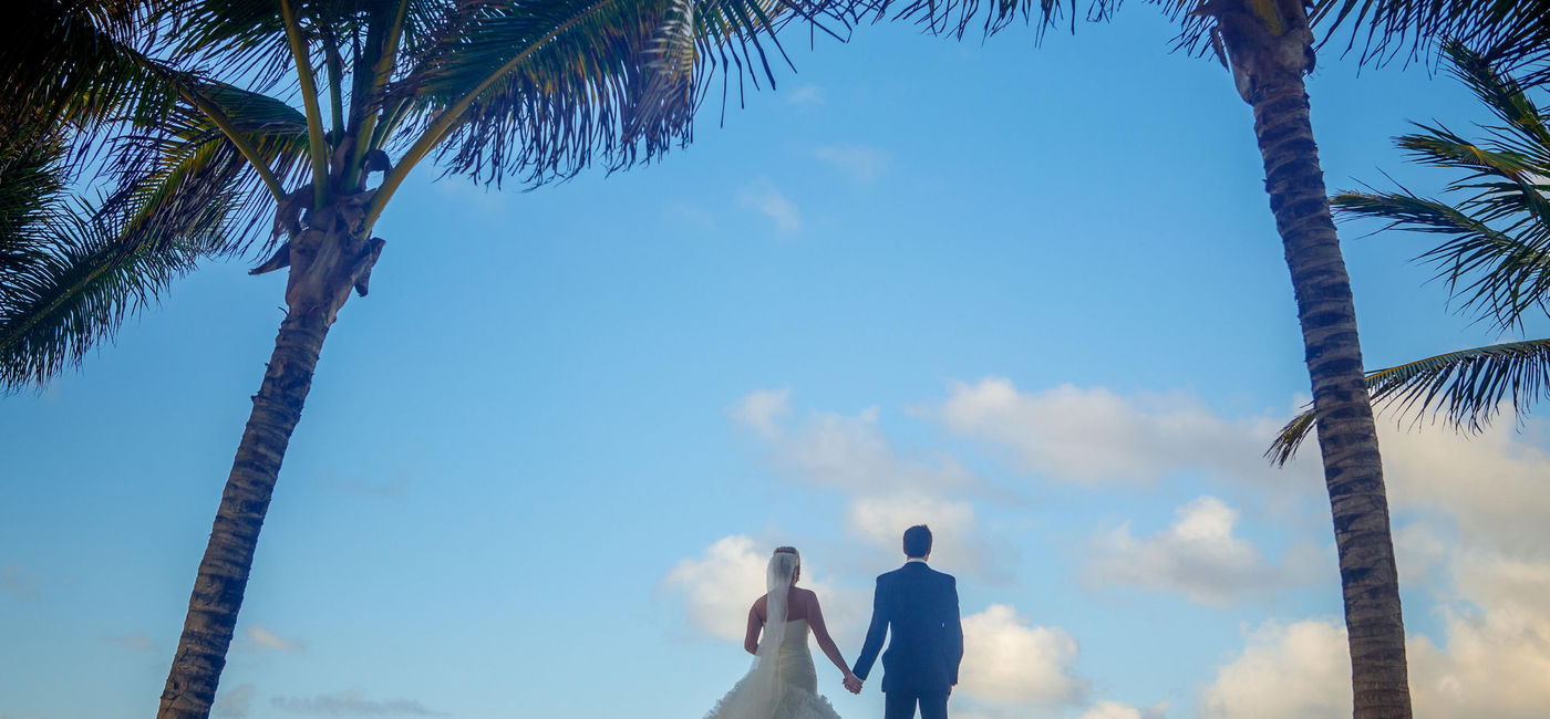 Image: Bride and groom on the beach for a destination wedding.  (Photo Credit: MandyElk/iStock/Getty Images Plus)