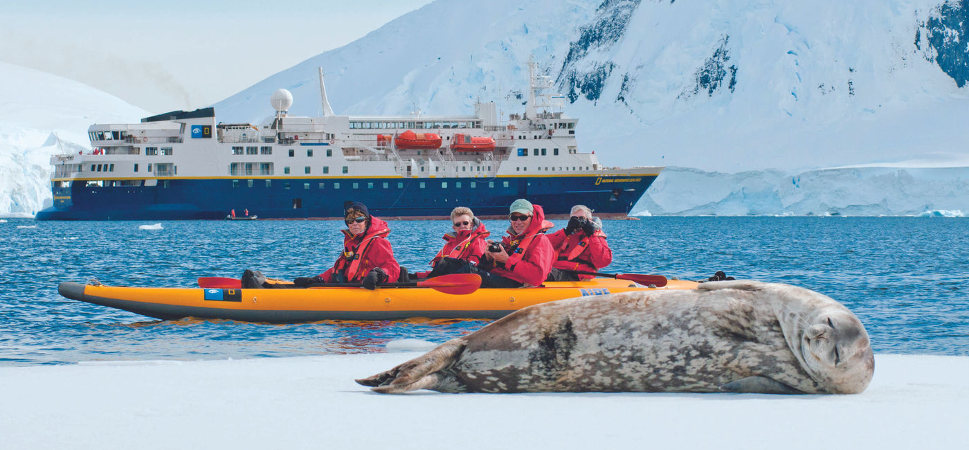 Image: Travelers in a kayak photograph a sleeping seal during a Lindblad Expeditions-National Geographic expedition cruise in Antarctica. (Photo Credit: Lindblad Expeditions-National Geographic)