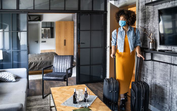 Women entering hotel room during COVID-19 pandemic.