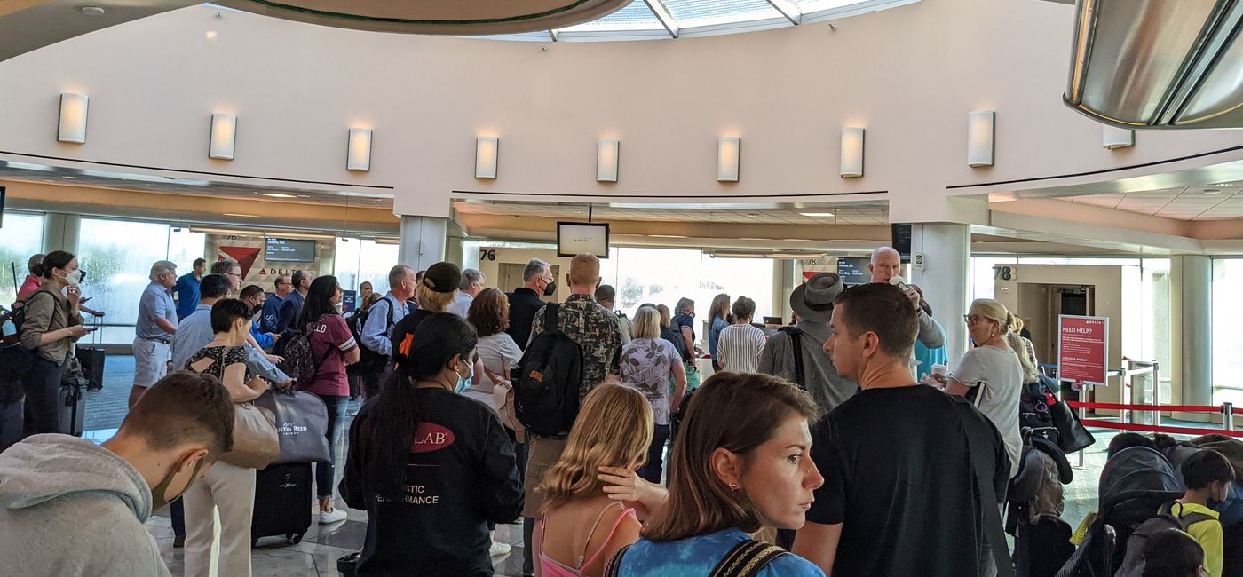 Image: Crowd of people waiting to board their flight at the airport (photo by Eric Bowman)