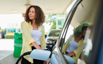Woman filling up at the pump.