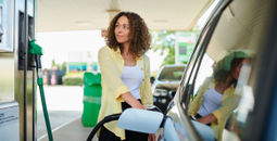 Woman filling up at the pump.