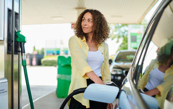 Woman filling up at the pump.
