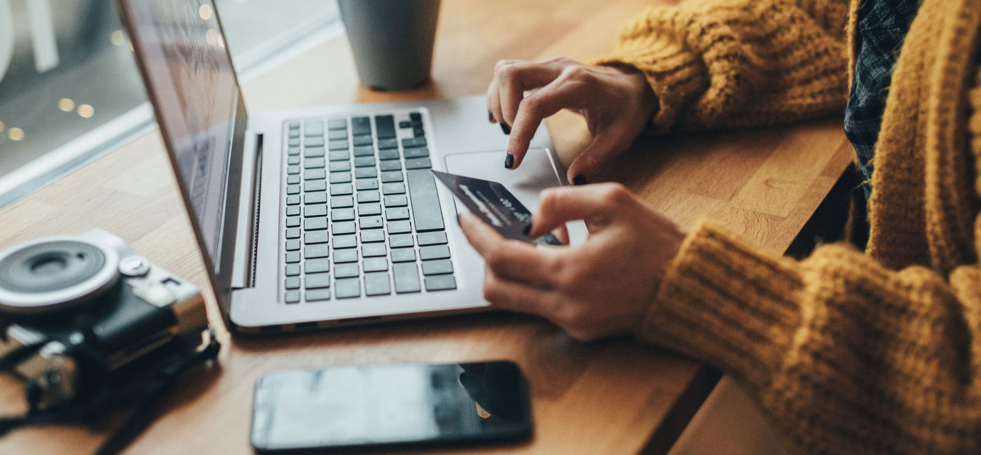 Image: Woman holiday shopping online. (Photo Credit: filadendron/E+)