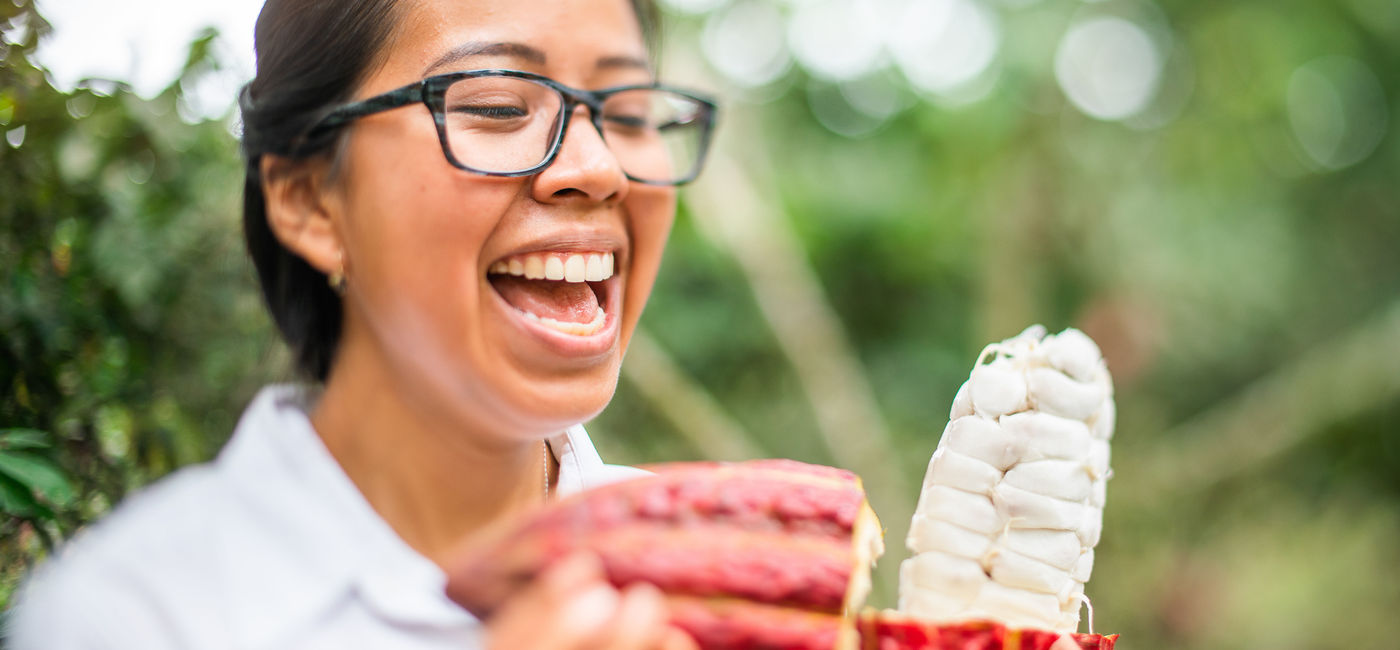 Image: Woman holds a cacao pod at Hacienda La Danesa. (photo via Touring Galapagos) ((photo via Touring Galapagos))