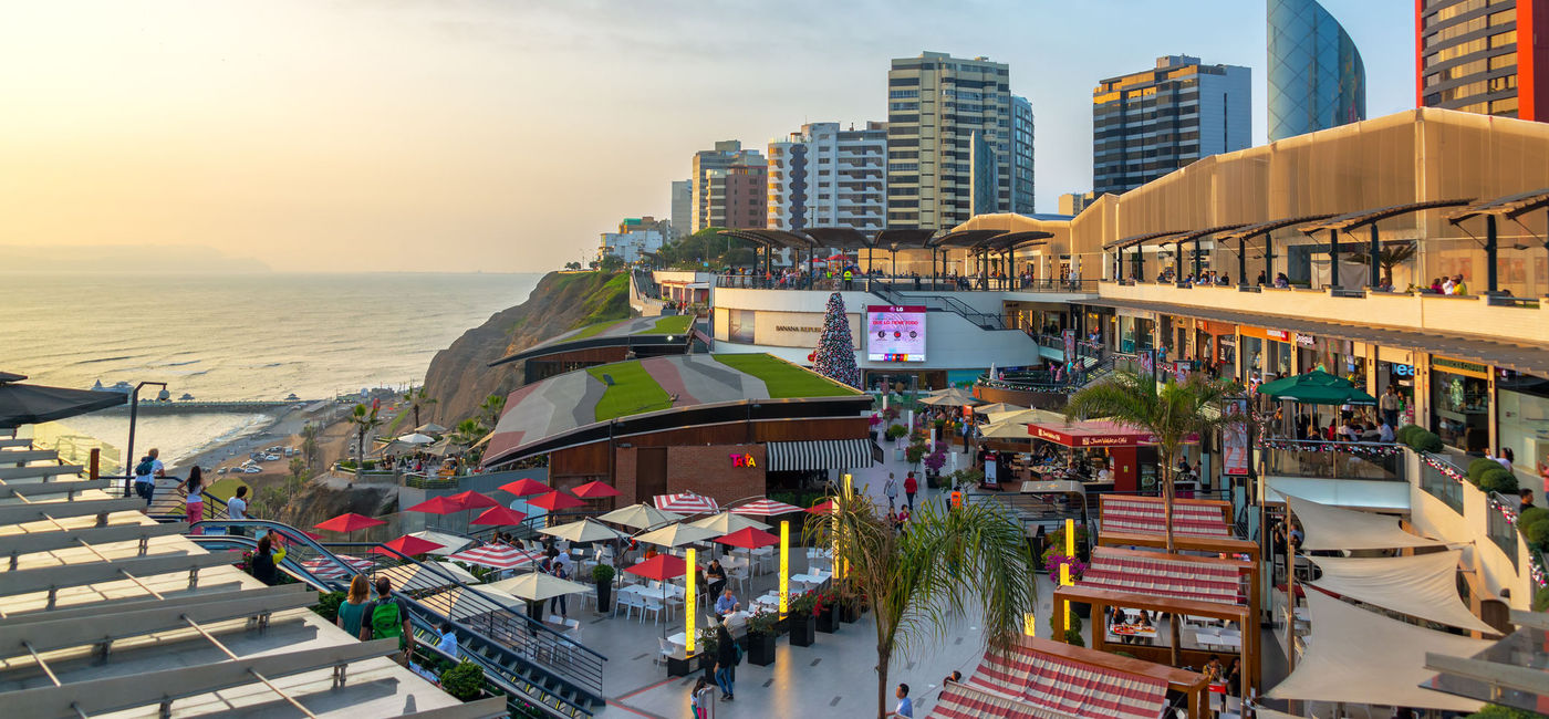 Image: A paraglider flies over the Larcomar in Lima, Peru. (Photo Credit: DC_Colombia/iStock Editorial/Getty Images Plus)