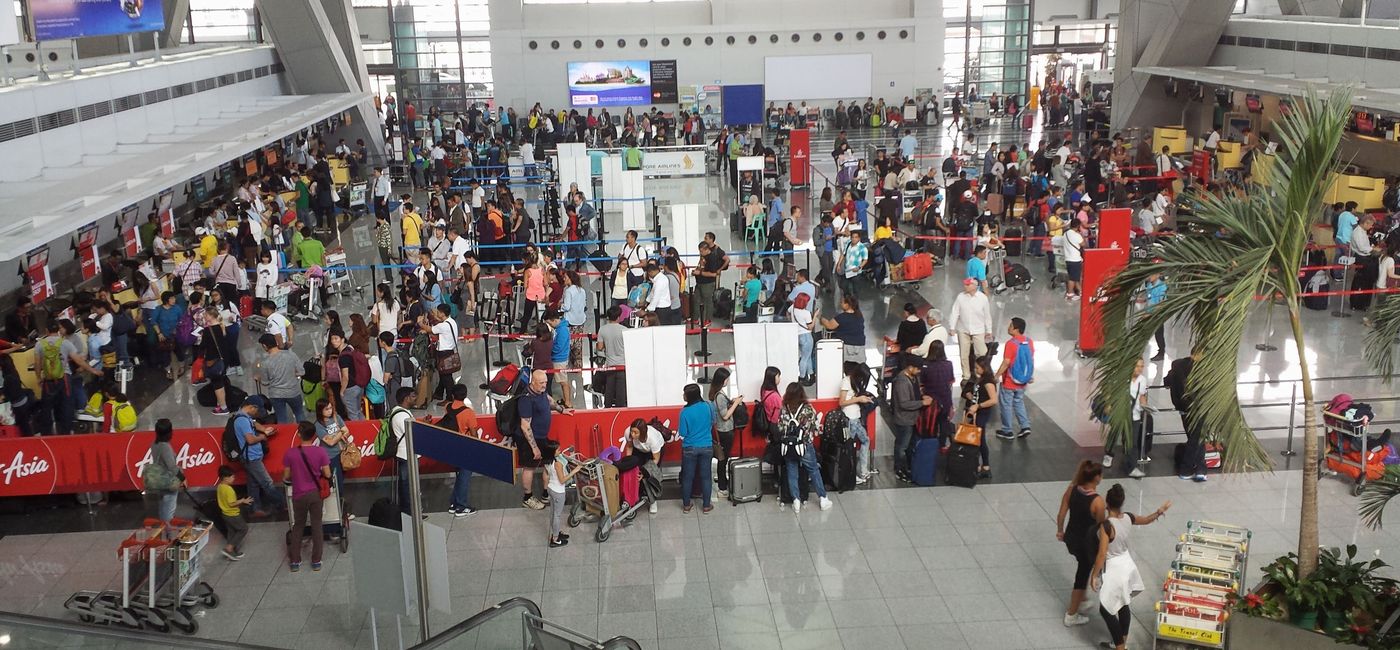Image: PHOTO: Passengers at the check-in counters inside of Ninoy Aquino International Airport in Manila, Philippines. (photo via raksyBH/iStock Editorial/Getty Images Plus)