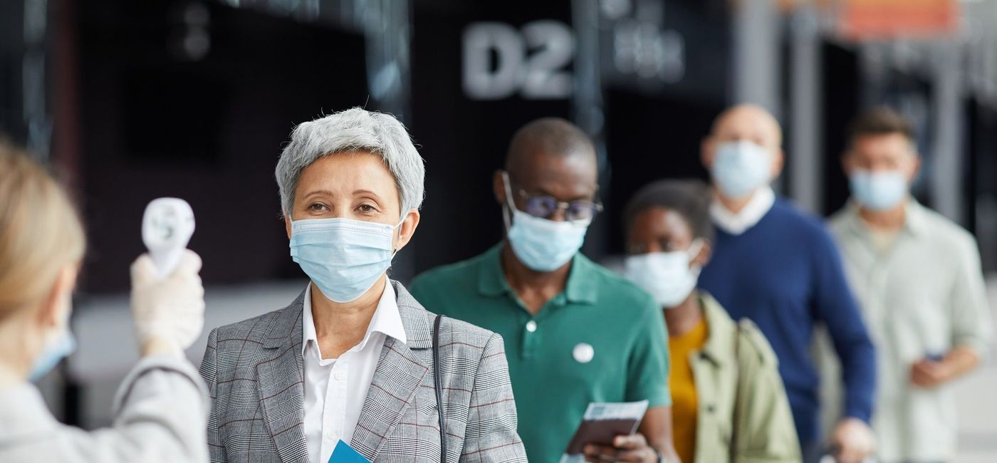 Image: A line for COVID-19 temperature check at the airport. (photo via iStock / Getty Images Plus / AnnaStills)