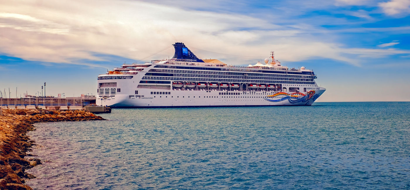 Image: PHOTO: Norwegian Spirit docked in Malaga, Spain. (photo via Roberto/iStock Editorial/Getty Images Plus)