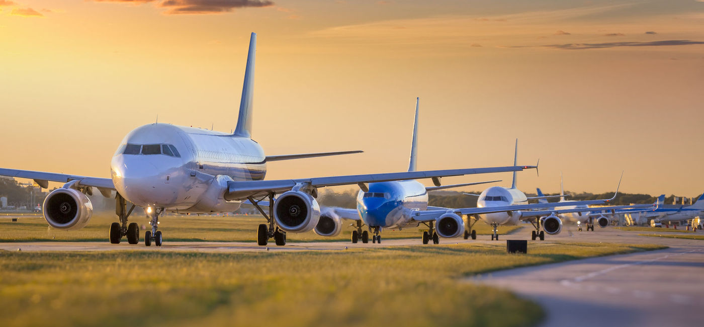 Image: PHOTO: Planes waiting to take off from airport. (photo via Grafissimo / E+)